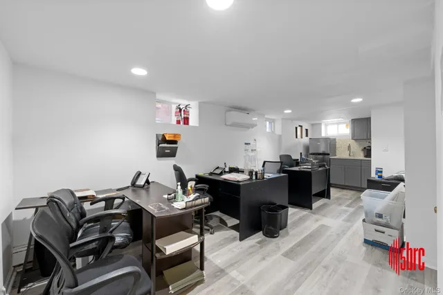 a living room with furniture and a dining table with kitchen view