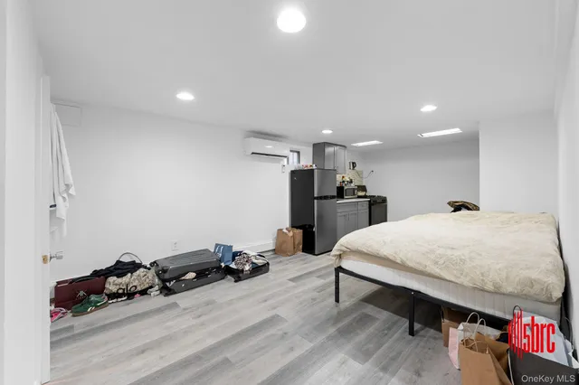 a bed room with a bed furniture and a flat screen tv