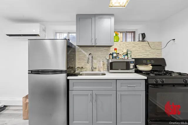 a kitchen with stainless steel appliances granite countertop a refrigerator a stove and a refrigerator