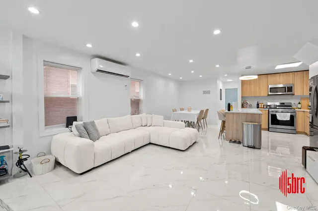 a living room with furniture and kitchen view