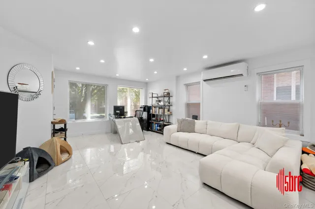 a living room with furniture and a gym machine