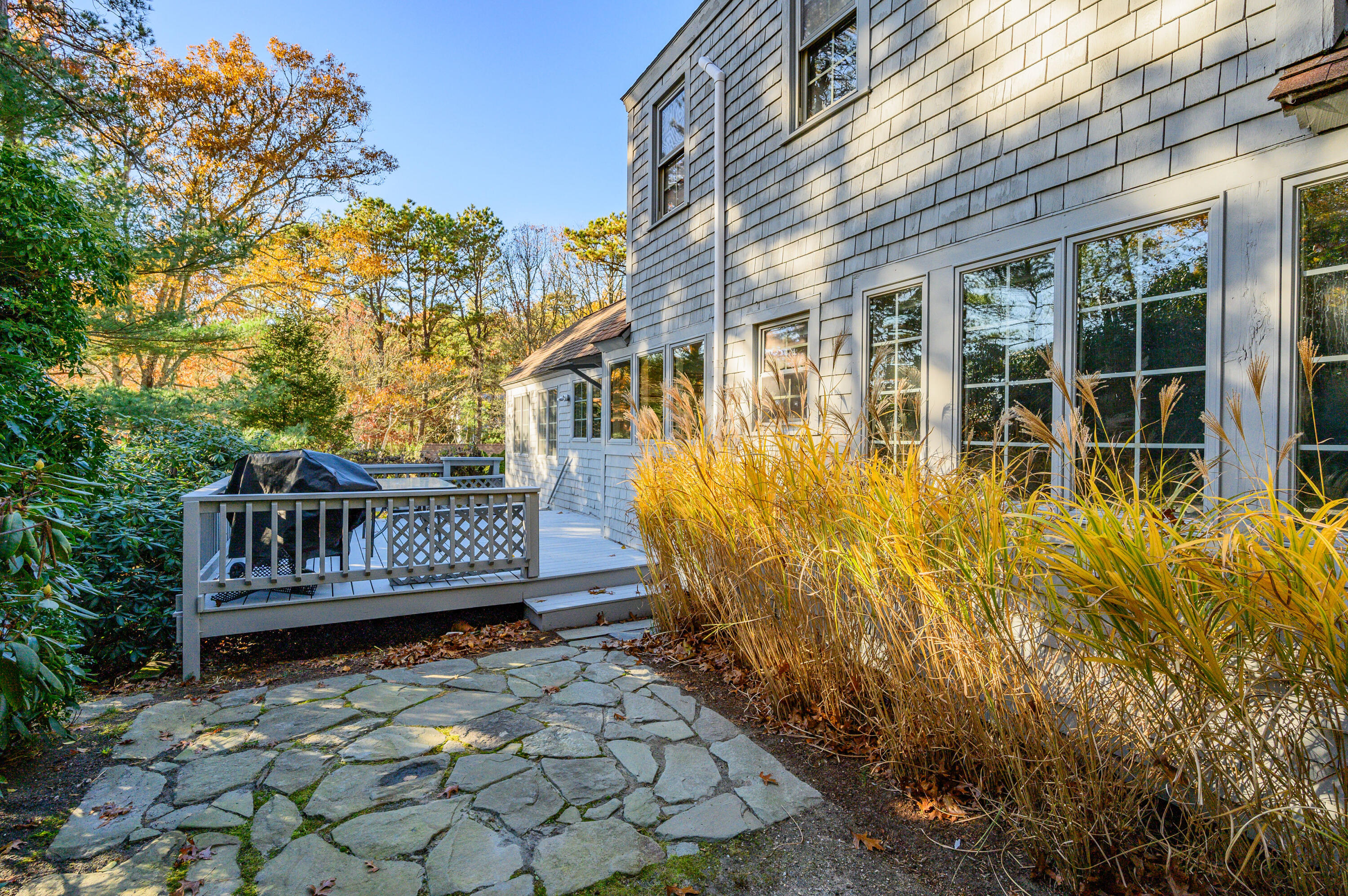 523 Bumps River Road Osterville, MA 02655 - Photo 33 of 49 a view of a house with a wooden deck and a yard