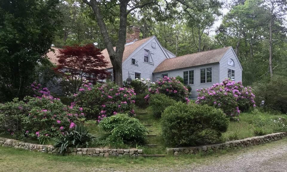 523 Bumps River Road Osterville, MA 02655 - Photo 4 of 49 a front view of a house with a garden and trees