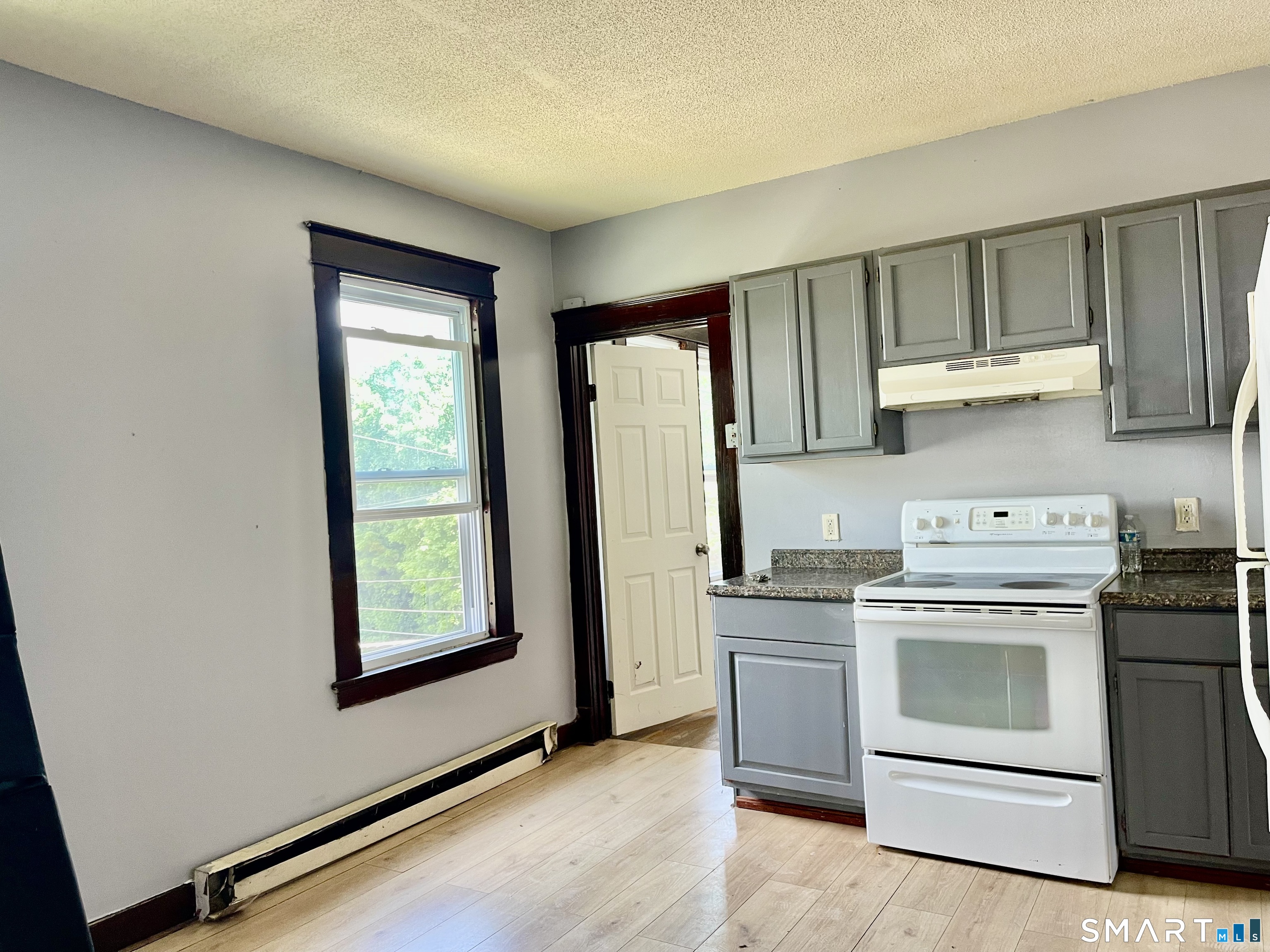 146 Charles Street, Unit 3 Waterbury, CT 06708 - Photo 6 of 20 a kitchen with a stove top oven sink and cabinets