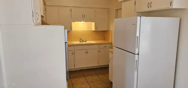 a white refrigerator freezer sitting in a kitchen