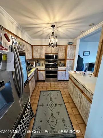 a kitchen with granite countertop a stove and cabinets