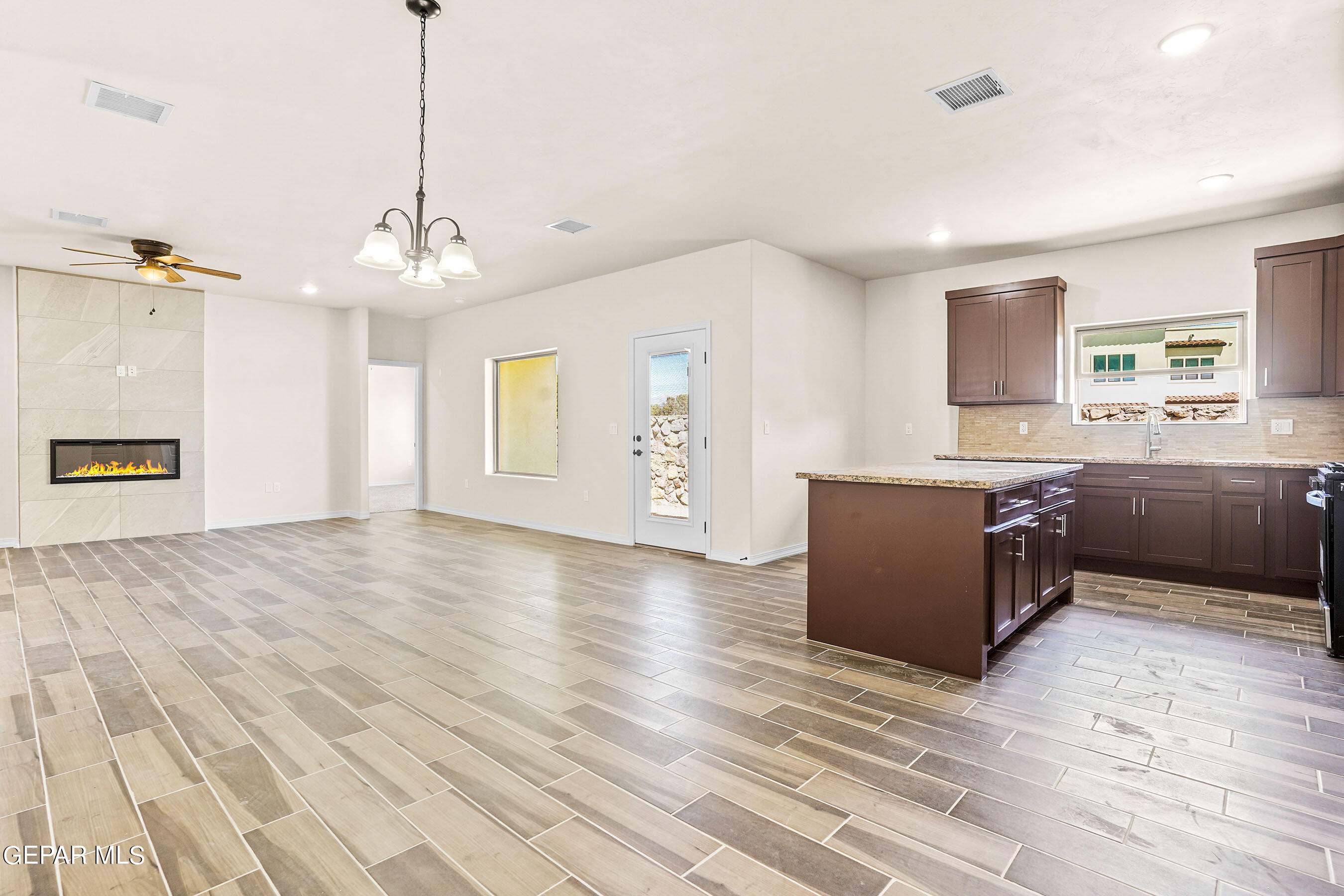 871 Country Club Road, Unit 4E El Paso, TX 79932 - Photo 14 of 34 a large room with a window and wooden floor