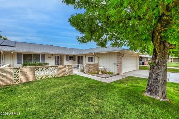 a front view of house with a garden and patio