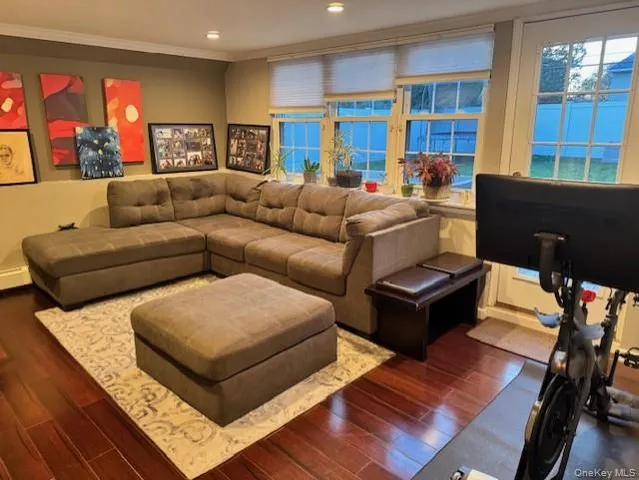 a living room with furniture and a bookshelf