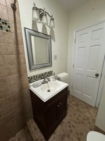 a bathroom with a sink a toilet and mirror
