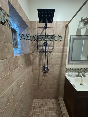 a bathroom with a sink toilet and shower