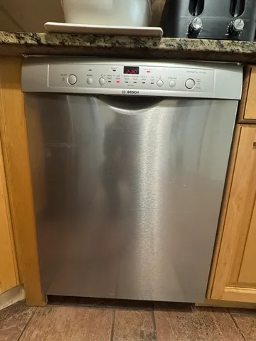 a view of a refrigerator with wooden floor
