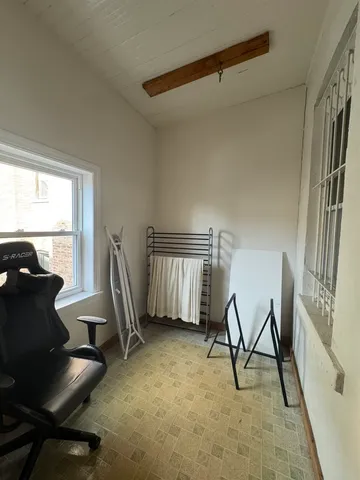 a view of a workspace with furniture and a window