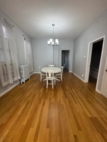 a view of a dining room with furniture and chandelier