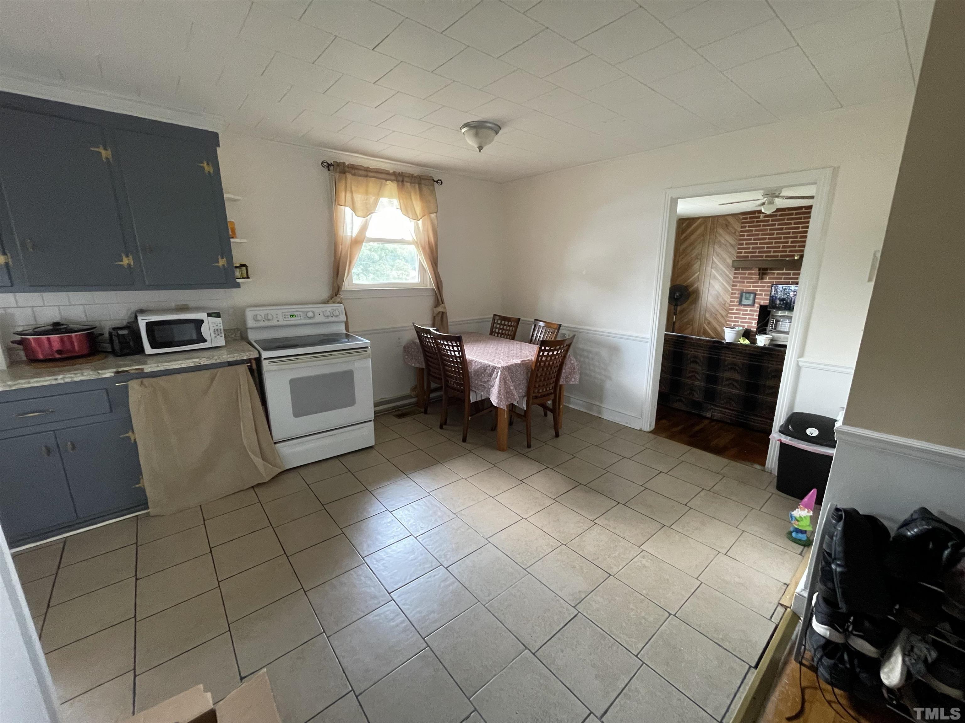 1416 Jackson Street Roxboro, NC 27573 - Photo 6 of 15 a kitchen with cabinets and chairs