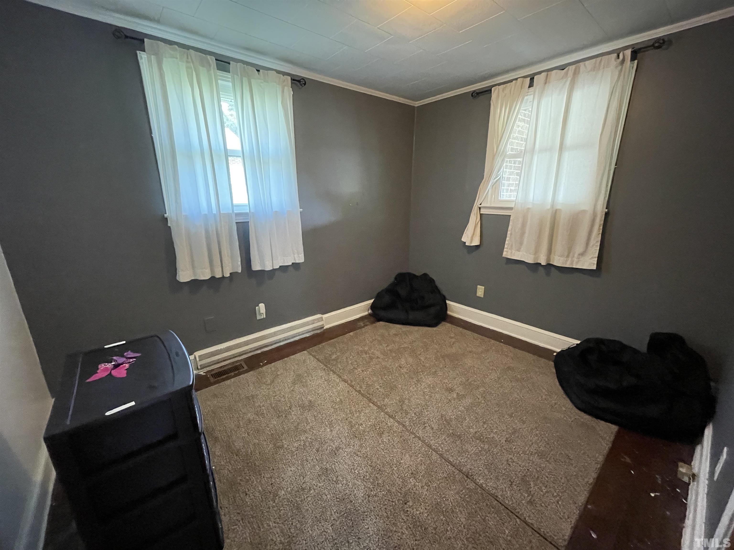 1416 Jackson Street Roxboro, NC 27573 - Photo 8 of 15 a bedroom with a bed and a window