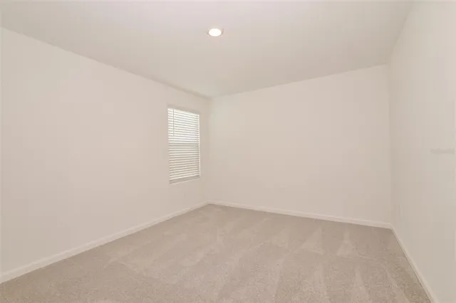 an empty room with a empty space and window