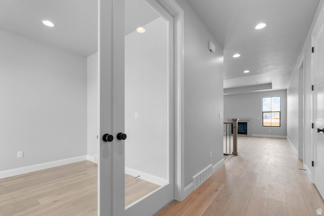11673 South Halls Crk Road Draper, UT 84020 - Photo 6 of 22 Interior hallway featuring light wood-finish flooring, recessed lighting, and crisp white trim