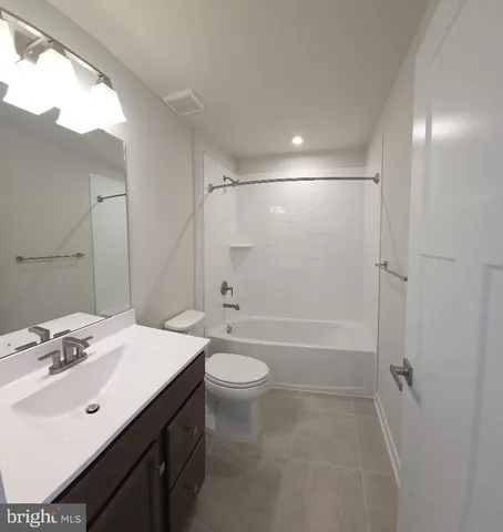 a bathroom with a double vanity sink toilet mirror and shower