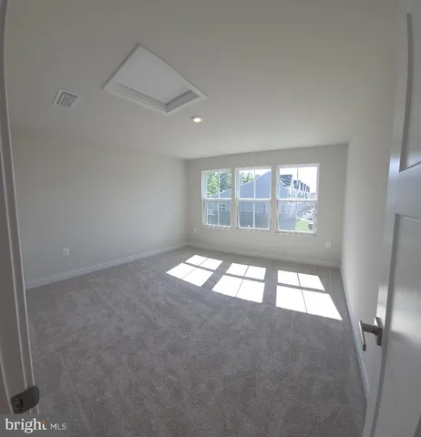 an empty room with large windows