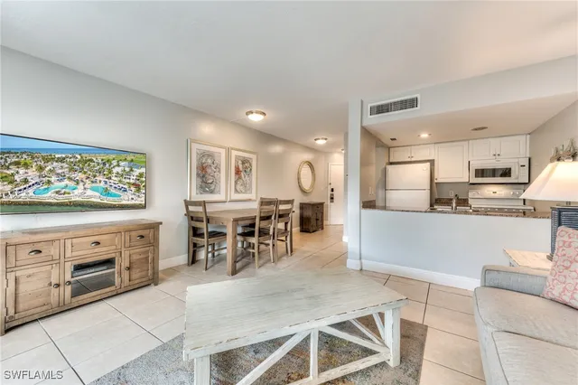 a living room with stainless steel appliances kitchen island granite countertop furniture and a kitchen view