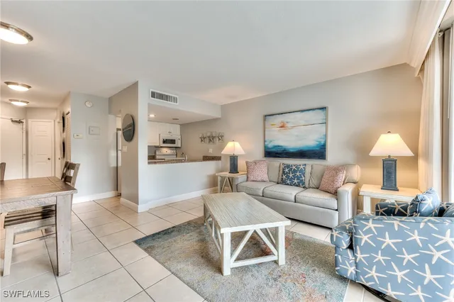 a living room with furniture and a lamp