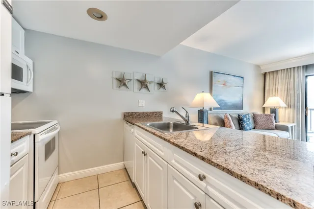 a view of living room with granite countertop furniture and fireplace