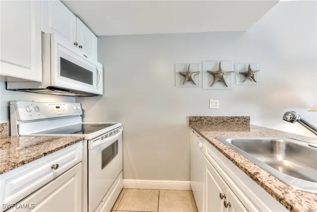 a kitchen with stainless steel appliances granite countertop a sink and a granite counter tops