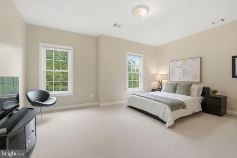 a view of a livingroom with workspace and a window