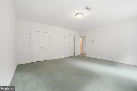 a backyard of a house with fountain table and chairs