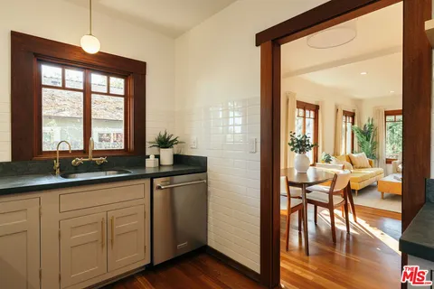 a kitchen with a stove and a wooden floors