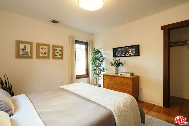 a bedroom with a bed and a plant