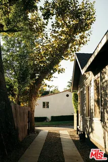 a couple of chairs sitting in backyard of a house