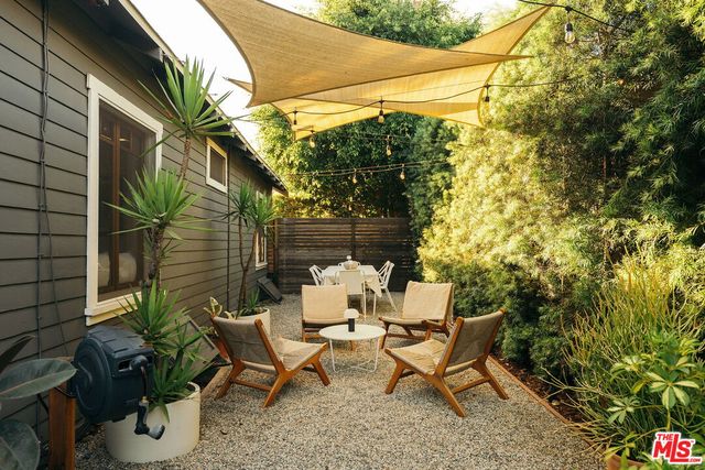 a backyard of a house with table and chairs