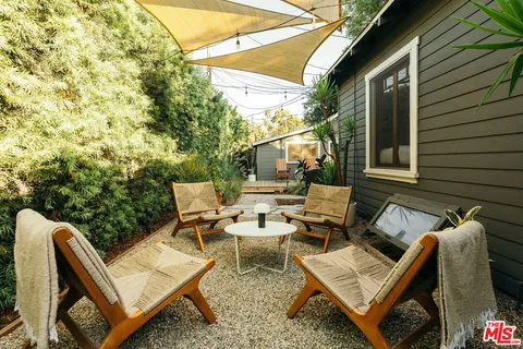 a backyard of a house with yard and outdoor seating