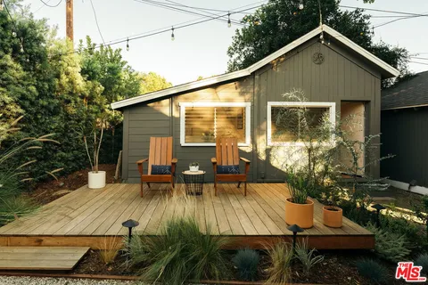 a view of a livingroom with furniture and a workspace