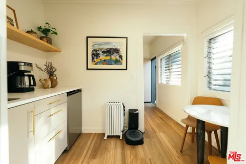 a front view of a house with shrubs