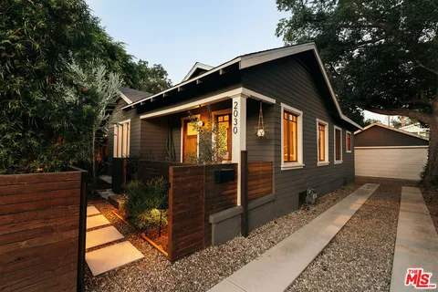 a backyard of a house with outdoor seating