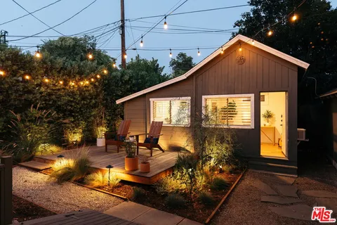 a view of a backyard with sitting area