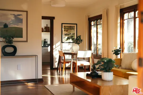 a view of a dining room with furniture and a potted plant