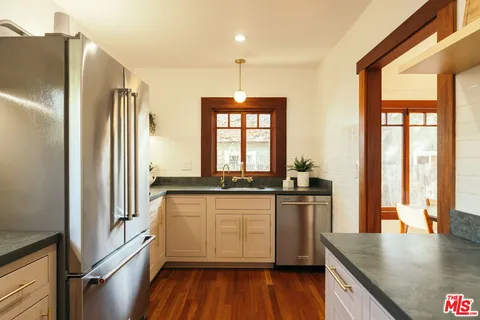 a kitchen with stainless steel appliances a refrigerator and a sink