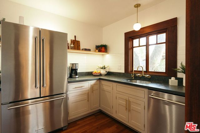 a kitchen with a sink and a large window