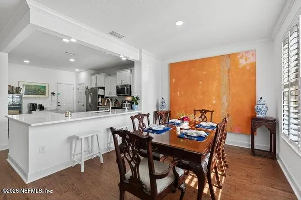 a view of a dining room with furniture and window