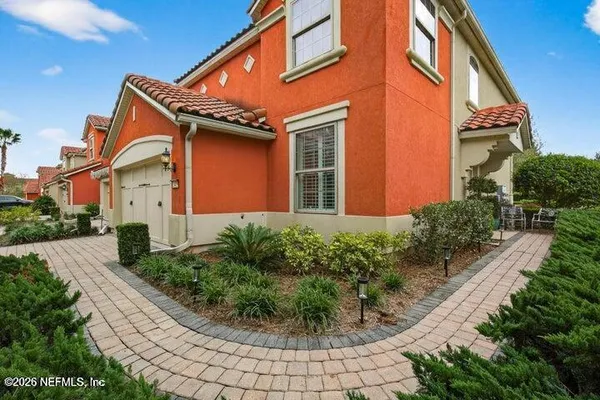 a front view of a house with garden