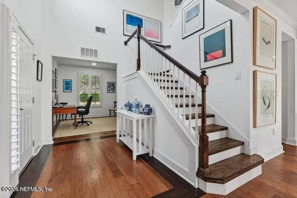 a view of entryway dining room and hall with wooden floor