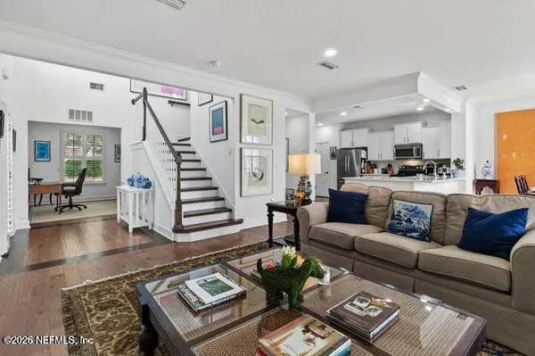 a living room with furniture and wooden floor