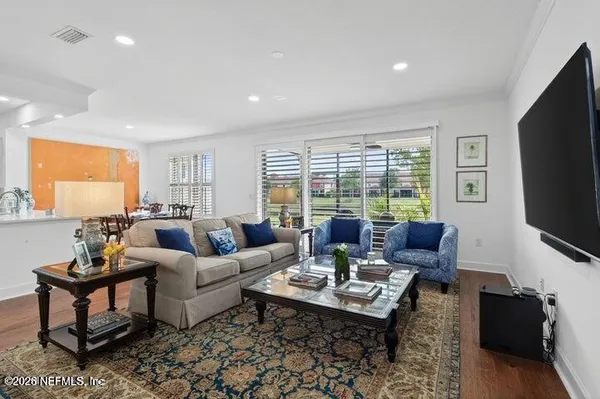 a living room with furniture a rug and a flat screen tv