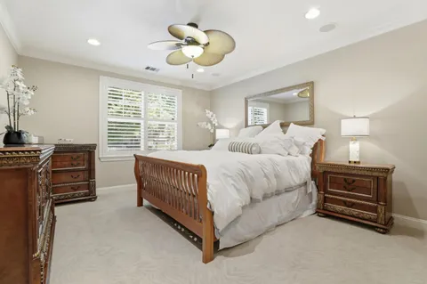 a spacious bedroom with a bed and a chandelier