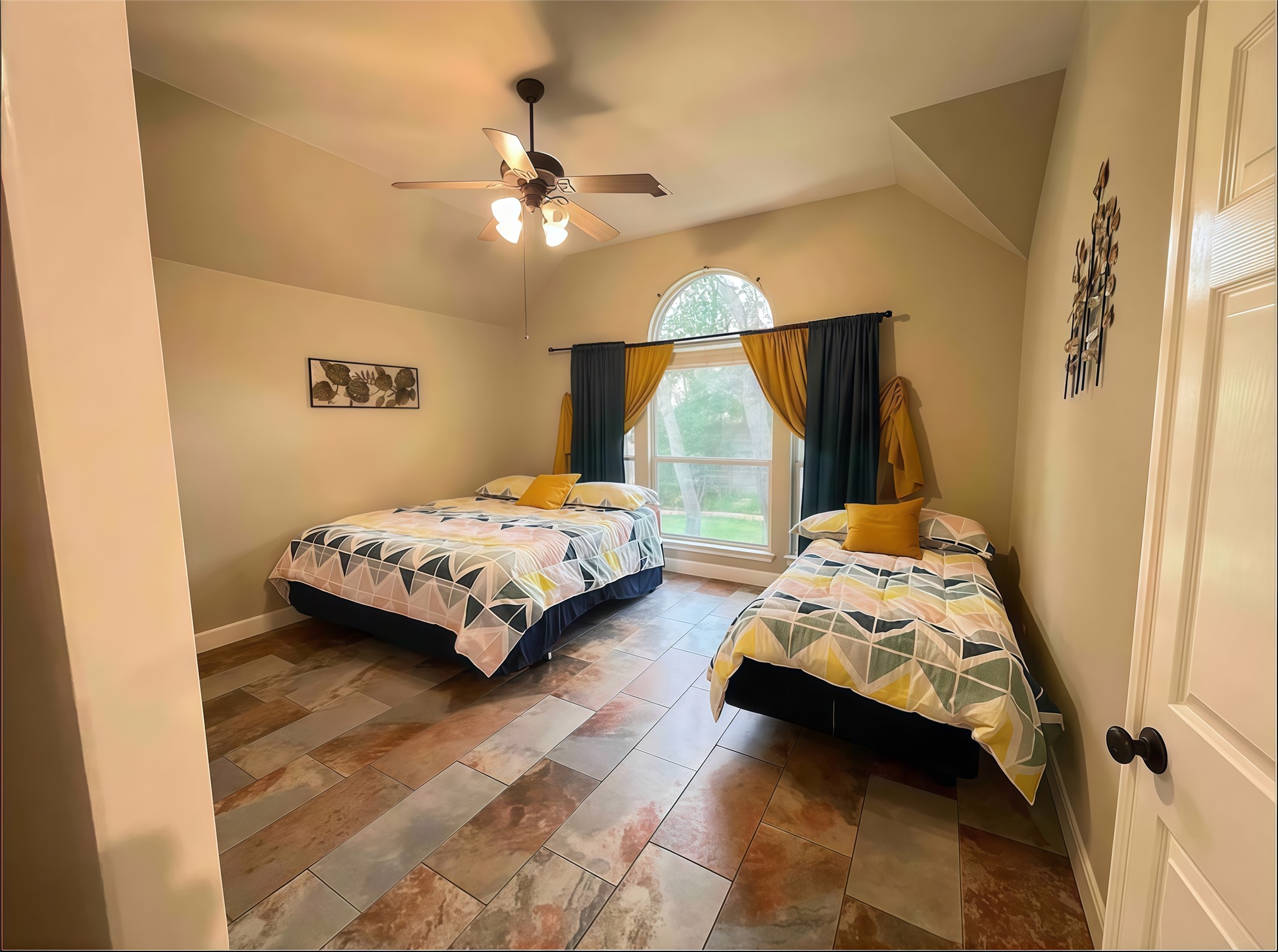 12616 Alberta Ridge Trail Austin, TX 78726 - Photo 19 of 26 A spacious bedroom showcases distinctive tiled flooring and a tall vaulted ceiling.