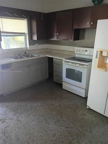 a kitchen with a stove sink and window